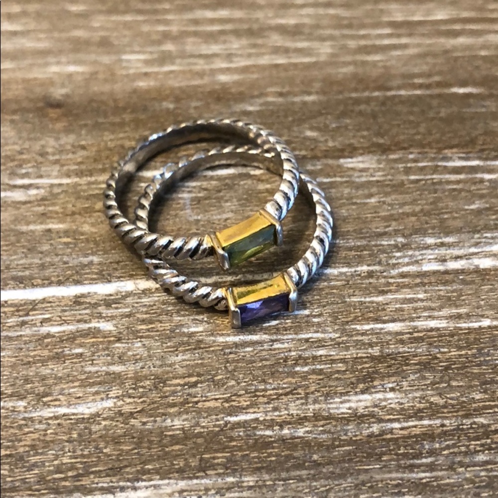 Stack rings with purple and green stone.